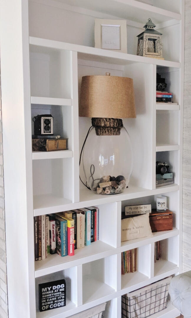 Custom built-in bookshelf with solid wood construction, designed and installed by TrueForm Interiors in Springfield, Missouri. Features adjustable shelving, a clean white finish, and integrated trim for a seamless look.